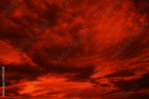 Obraz na płótnie Abstract dark red background. Dramatic red sky. Red sunset with clouds. Fantastic sunset background with copy space for design. Halloween, armageddon, apocalypse, end of the world concept. w salonie