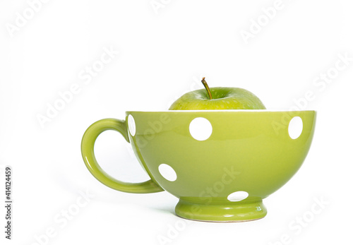 Green cup with green apple.