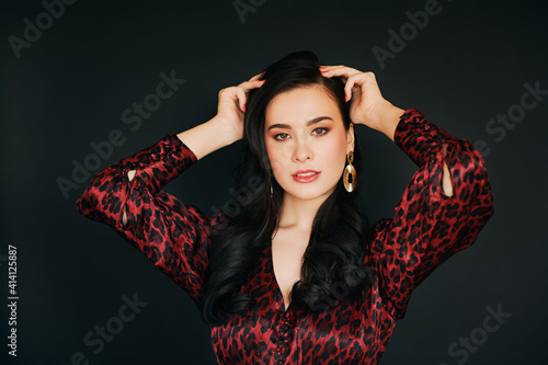 Fashion portrait of beautiful asian woman  professional makeup and hair styling  wearing red leopard print dress