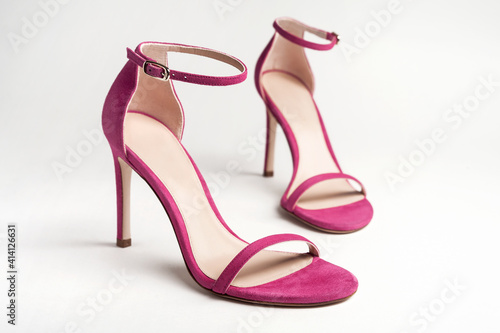 Canvastavla Woman's pink high heels shoes with ankle strap on a white background
