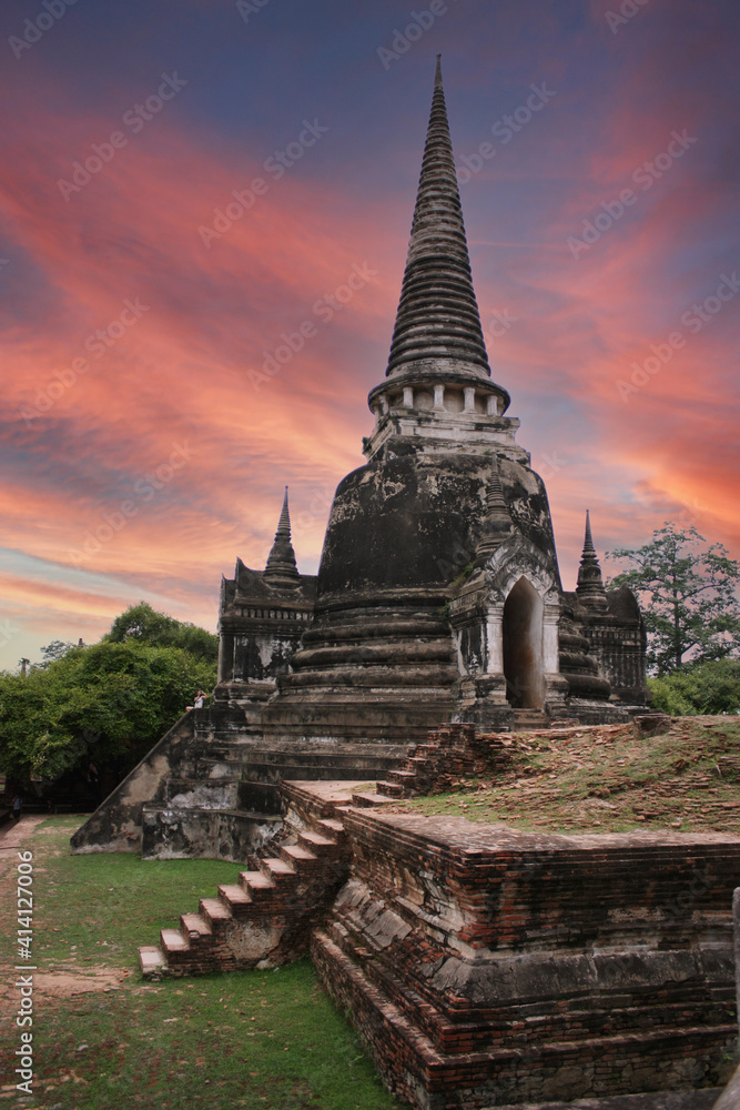 Fototapeta premium ancient old pagoda was built from laterite in thai temple with twilight sky at ayutthaya