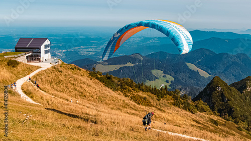 Beautiful alpine summer view with a paraglider at the famous Hochfelln summit, Bergen, Bavaria, Germany photo