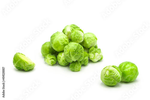 Fresh organic brussels sprouts whole and halves isolated on white background.