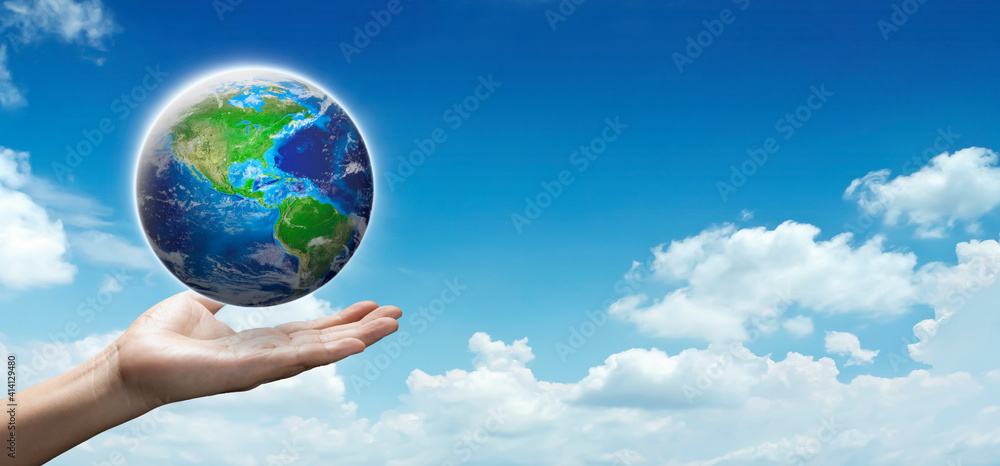 Hand hold planet earth on cloudy blue sky show Environment Day, Ecology, Global warning, save protect and love earth concept. World in hand on vertical with text space.Elements image furnished by NASA Hand hold planet earth on cloudy blue sky show Environment Day, Ecology, Global warning, save protect and love earth concept. World in hand on vertical with text space.Elements image furnished by NASA
