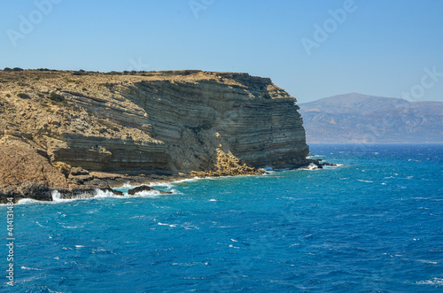 Huge rocks, turquoise sea water, and blue Cycladic sky