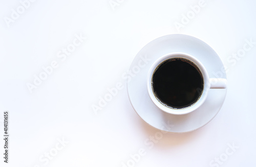 Flat lay of hot americano coffee in white coffee cup on white background with copy space 