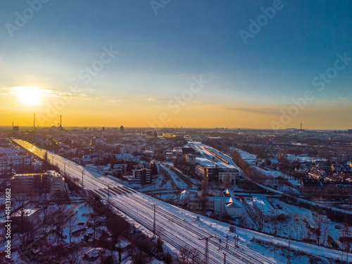 View of the snow-covered skyline of Duisburg at sunset from above