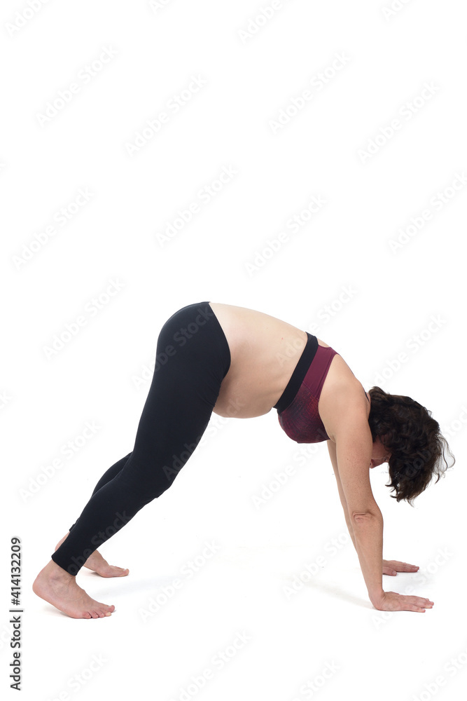 portrait of a pregnant woman exercising on white background, floor exercise
