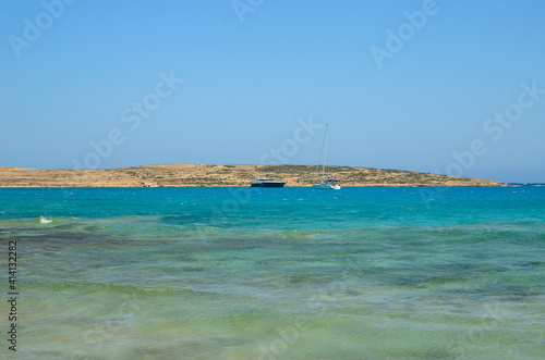 Sand, turquoise sea water, and blue Cycladic sky © Panos