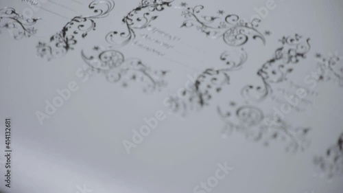 Close-up view. Automatic line for printing on paper. Stamping, foil and glitter. Relief. Concept for printing, industrial production of cardboard packaging and printing.