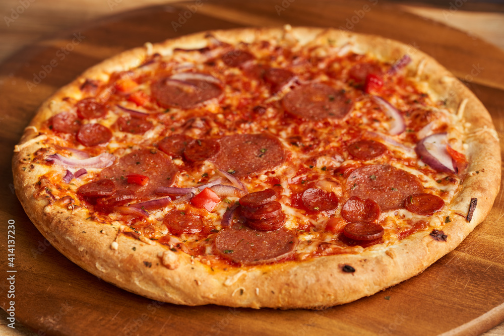 Pepperoni pizza on a wooden board
