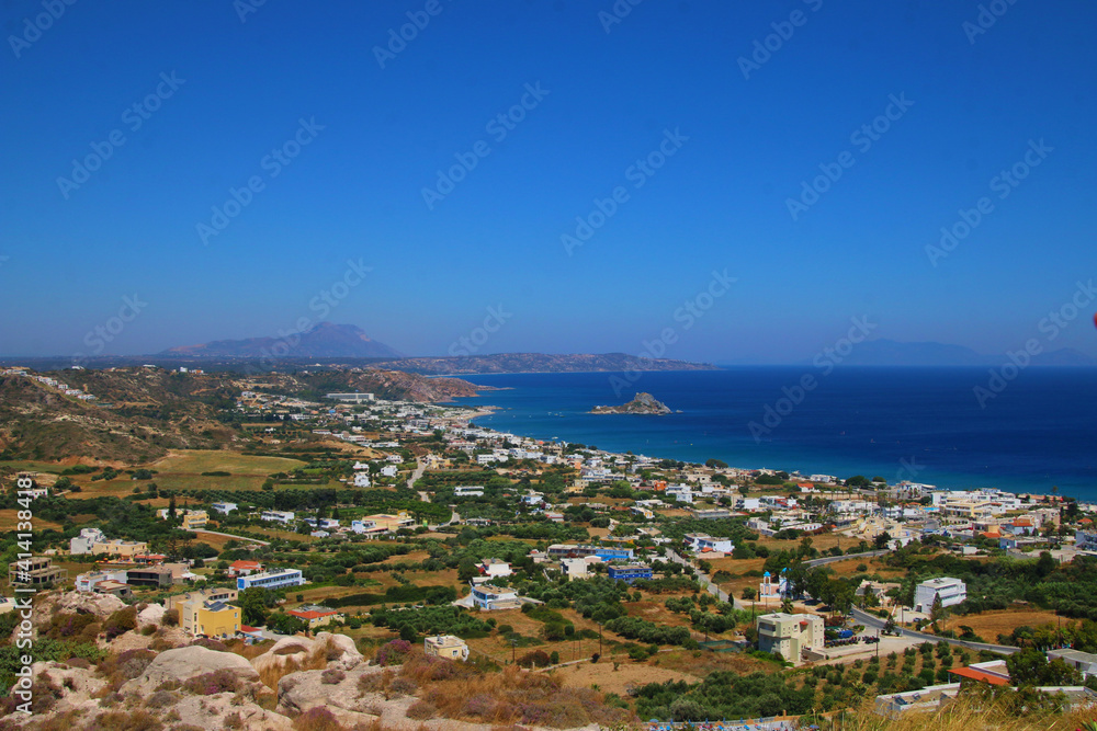 Naklejka premium Beach framed by cliffs on beautiful island Majorca. Nice sunset on beach with trees in nature outside in Spain. Beautiful blue water and white sand beach. white houses on the cliffs.