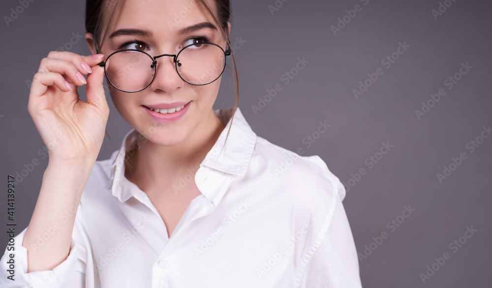 Business lady in round glasses and a close-up shirt. Business lady in round glasses and a close-up shirt.