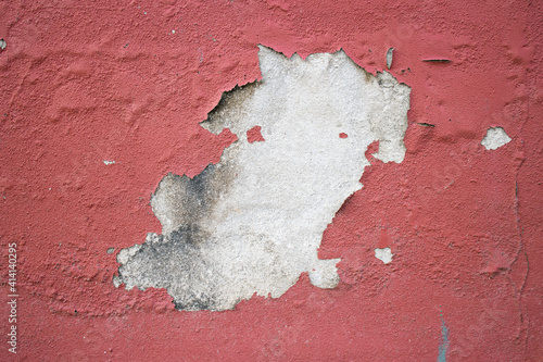 textured wainscoting wall paneling with cracked paint chips falling off. antique old aged painted finish. distressed building wall. background and texture photo