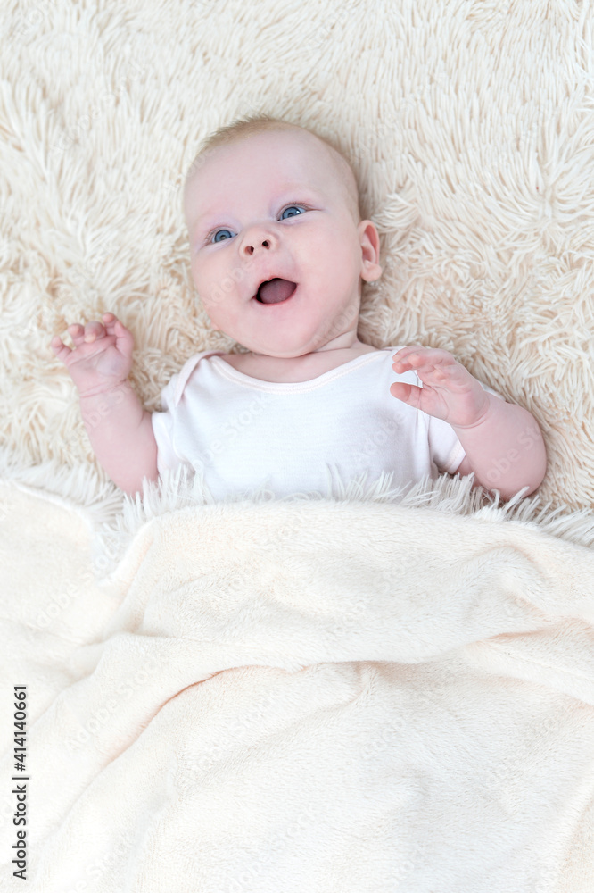 cute little baby girl lying under the blanket cute little baby girl lying under the blanket