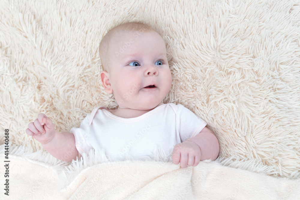 cute little baby girl lying under the blanket cute little baby girl lying under the blanket