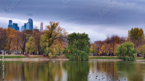 Park Novodevichy Ponds and view of Moscow City. Skyscrapers and cloudy weather. Lake in autumn. Russia.