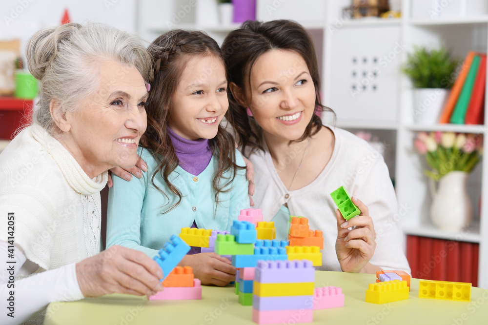Little girl playing with mother and grandmother Little girl playing with mother and grandmother