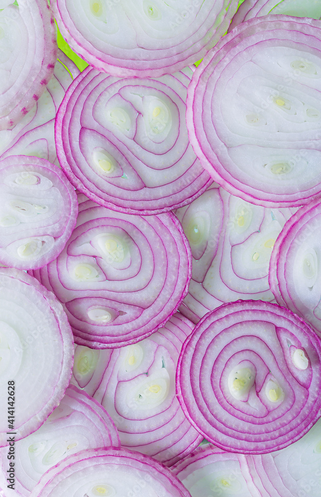 Background of red onion rings lying next to each other isolated on white background Background of red onion rings lying next to each other isolated on white background