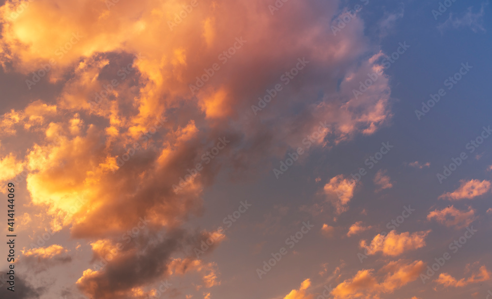 Natural sky background. Bright sunset with orange clouds.