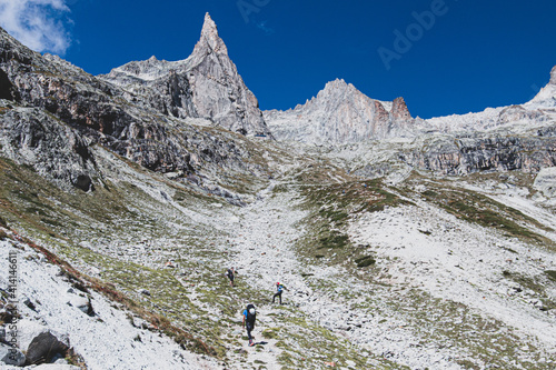 Hiking with climbing gear to Dibona peak, Ecrins, French Alps, France photo