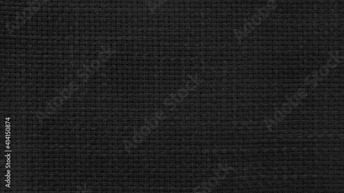 dark black linen texture, burlap fabric as background. close up black weaving or mesh fabric texture background. 