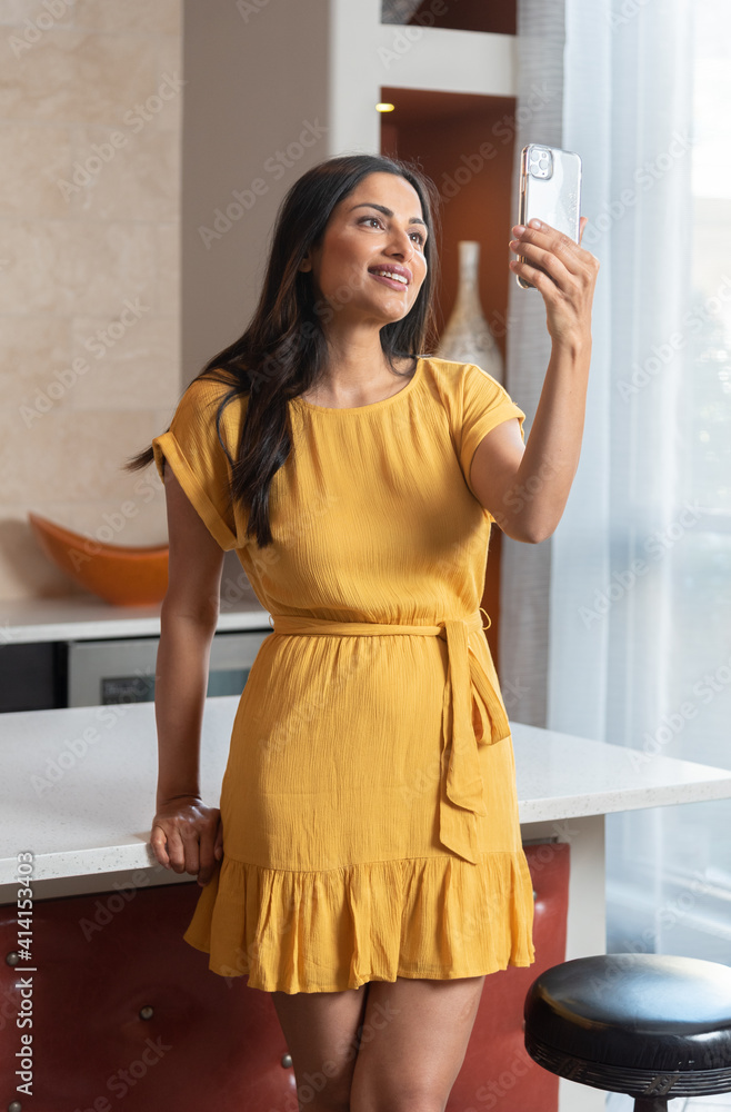 Beautiful Asian Indian woman talking / texting on mobile phone Beautiful Asian Indian woman talking / texting on mobile phone