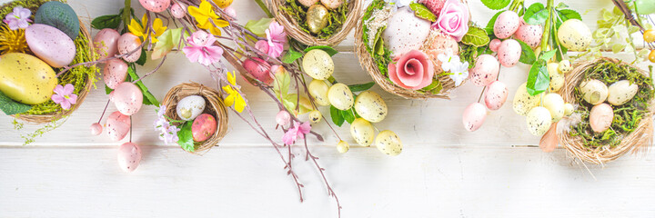 Happy easter background with Nests decoration, colorful eggs and Spring Flowers. Caster card on sunny spring background