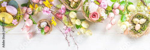 Wall Mural Happy easter background with Nests decoration, colorful eggs and Spring Flowers