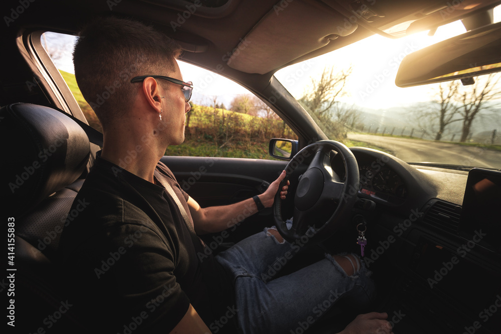 Young caucasian man driving a sports car
