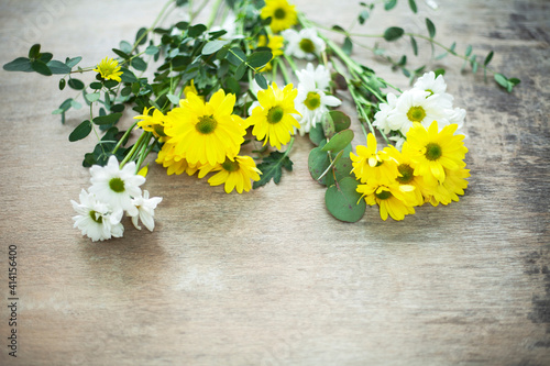 Bouquet daisy chamomile flowers on wooden garden table.