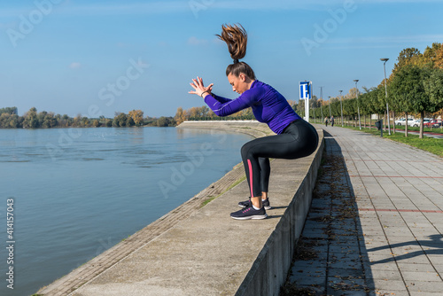 Young sexy sweaty muscular fit woman practicing outdoor jumping on the wall for hardcore cross workout training out of the gym © Srdjan