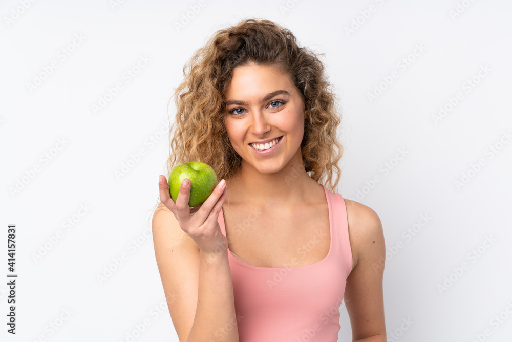 Young blonde woman with curly hair isolated on white background with an apple Young blonde woman with curly hair isolated on white background with an apple