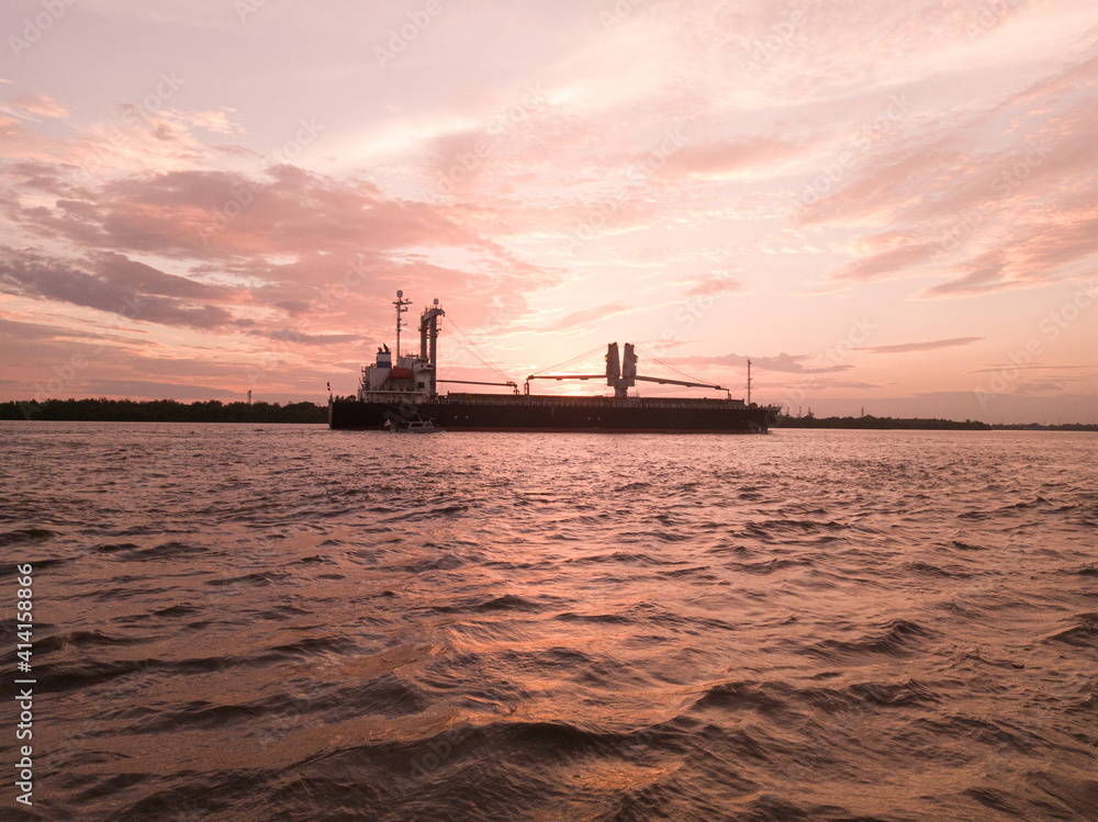 sunset in the river and container ship