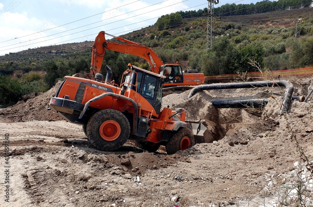 bulldozer at work, excavator on a construction site , earthwork , excavation , construction site 