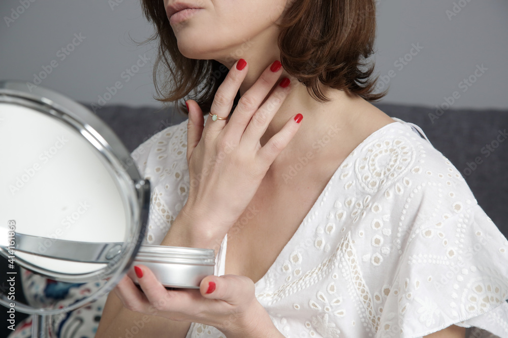 Woman using skin care products in front of the mirror at home. Domestic life, home spa, self care and pampering concept. Woman using skin care products in front of the mirror at home. Domestic life, home spa, self care and pampering concept.