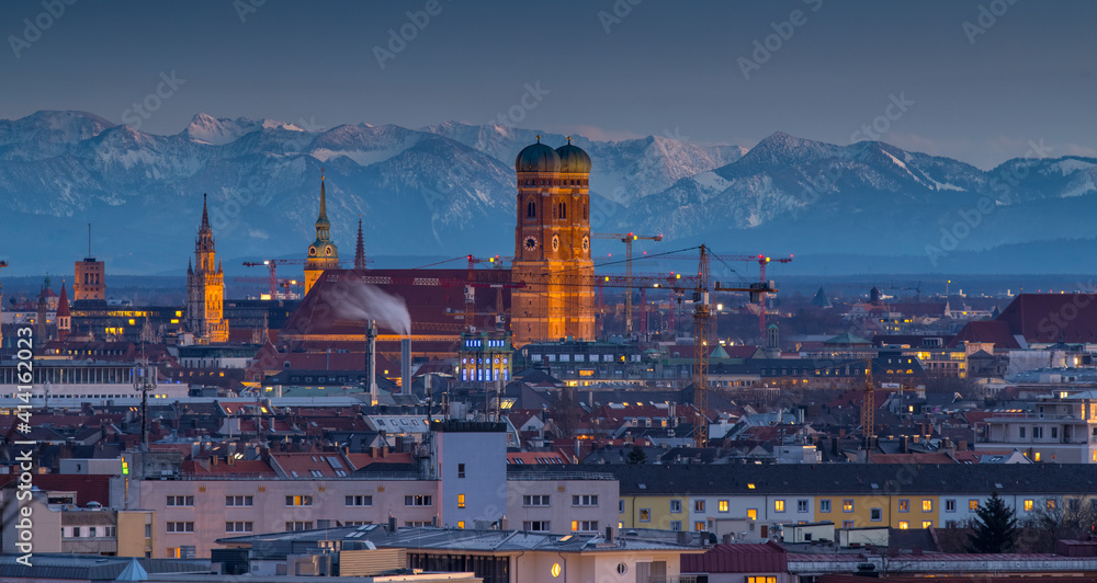 Fototapeta premium Munich cityscpae at night frauenkirche church skyline aerial view alps mountains winter.