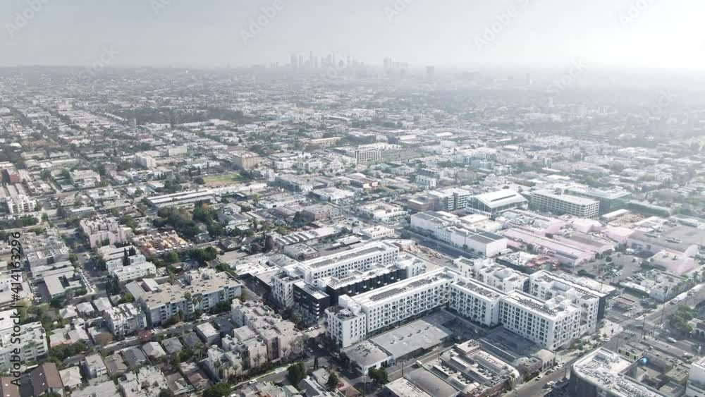 Drone aerial shot 4k. Hollywood neighborhood with views of downtown Los Angeles. office skyscrapers buildings in LA center. Smog air pollution smog due to forest fires. Drone aerial shot 4k. Hollywood neighborhood with views of downtown Los Angeles. office skyscrapers buildings in LA center. Smog air pollution smog due to forest fires.