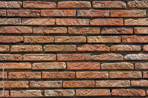 Old rough orange brick wall grunge texture. Vintage architectural background.