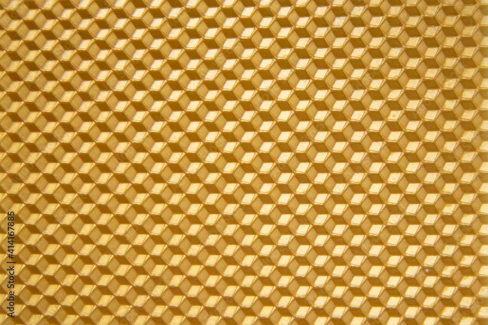 Gold beeswax for candle, texture. Honeycomb background from a bee hive. Gold beeswax for candle, texture. Honeycomb background from a bee hive.
