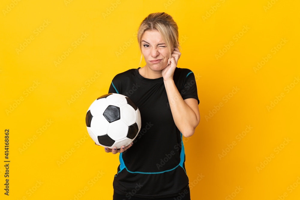 Young Russian football player woman isolated on yellow background frustrated and covering ears Young Russian football player woman isolated on yellow background frustrated and covering ears