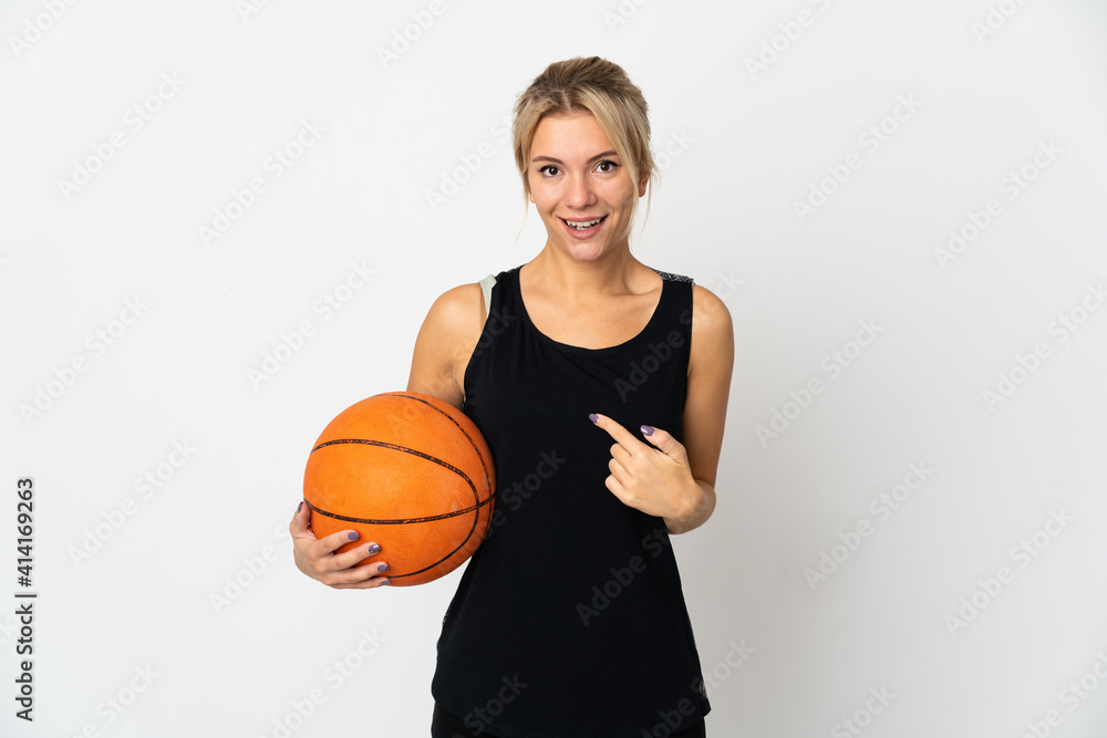 Young Russian woman playing basketball isolated on white background with surprise facial expression