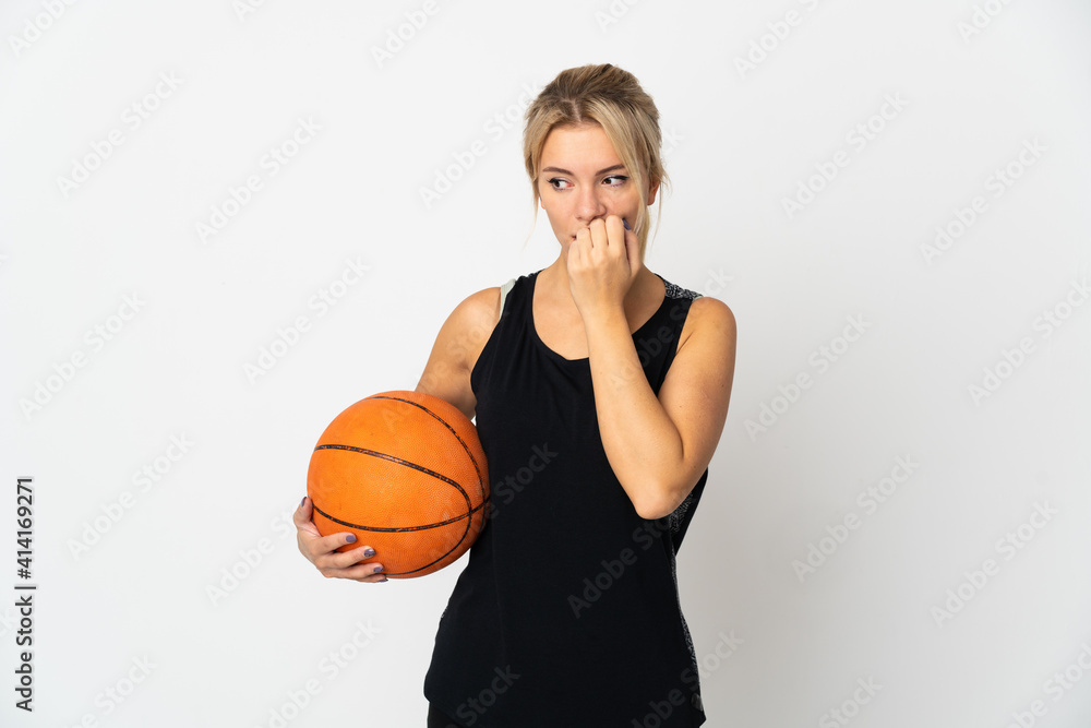 Young Russian woman playing basketball isolated on white background having doubts