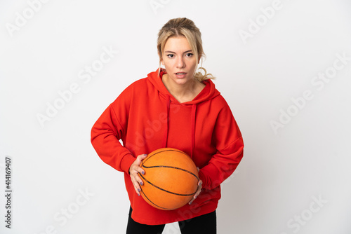 Young Russian woman isolated on white background playing basketball