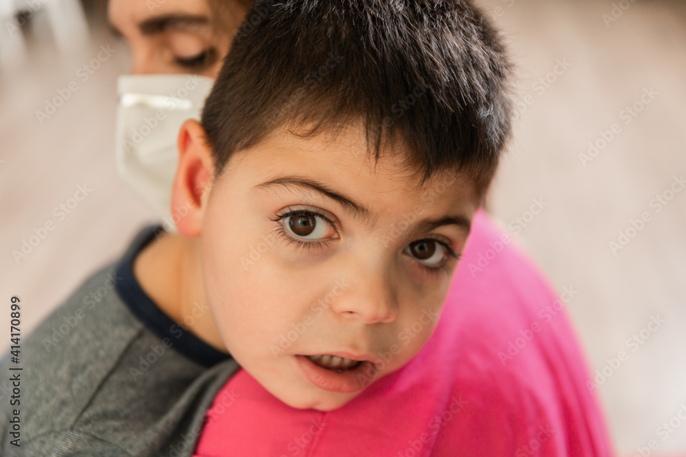 child with disabilities is hugged by nurse wearing protective mask child with disabilities is hugged by nurse wearing protective mask
