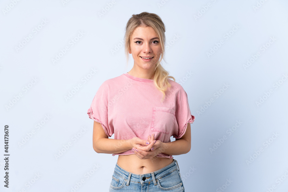 Blonde woman over isolated blue background laughing Blonde woman over isolated blue background laughing