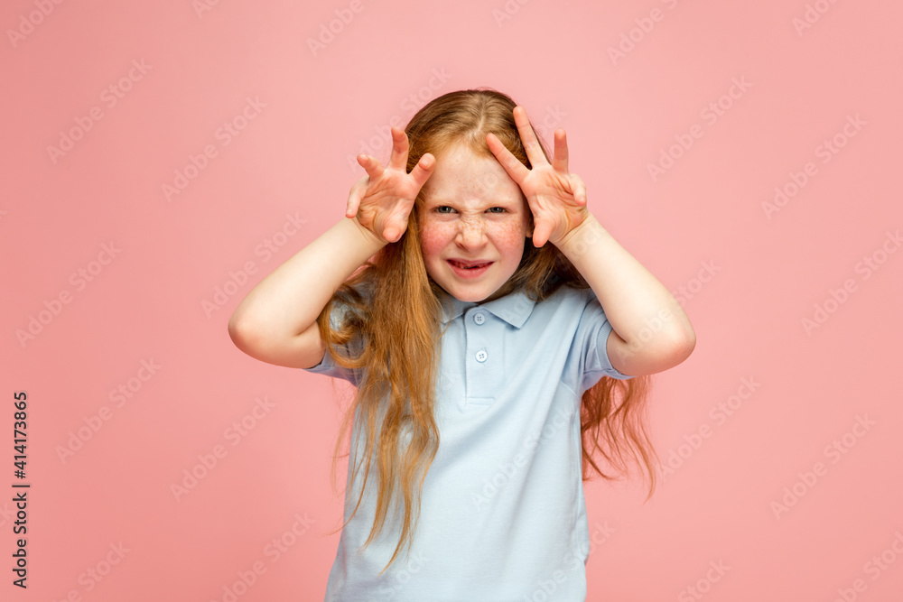 Peek-a-boo, gremaces. Happy, smiley redhair girl isolated on pink studio background with copyspace for ad. Looks happy, cheerful. Childhood, education, human emotions, facial expression concept. Peek-a-boo, gremaces. Happy, smiley redhair girl isolated on pink studio background with copyspace for ad. Looks happy, cheerful. Childhood, education, human emotions, facial expression concept.