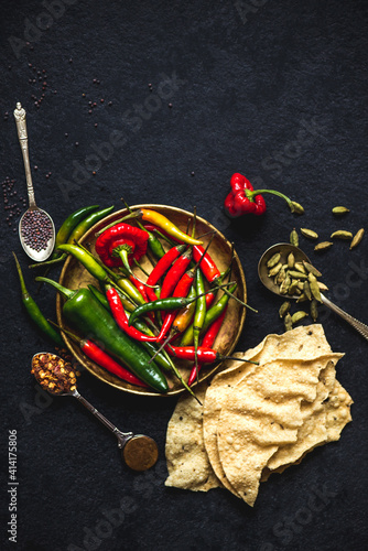 Indian cooking ingredients: chilli peppers, cardamom, black mustard seeds, poppadoms photo