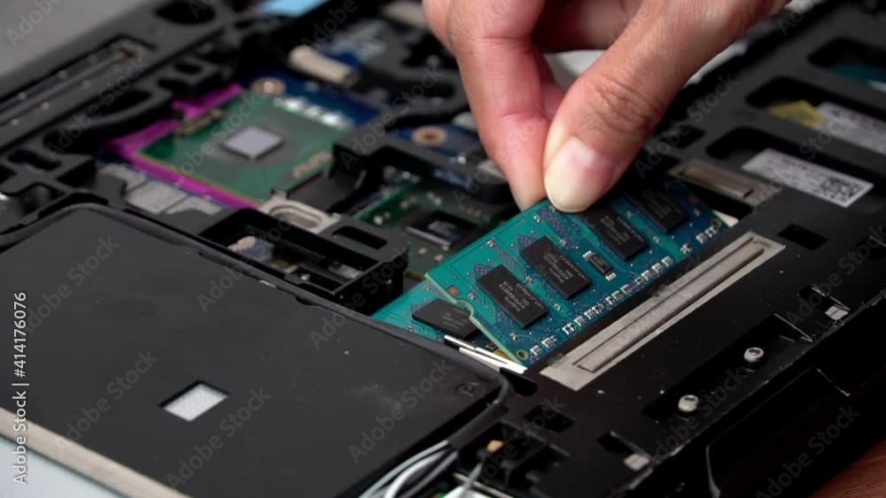 Laptop repair engineer (PC computer) and motherboard install RAM in computer lab top. Laptop repair engineer (PC computer) and motherboard install RAM in computer lab top.