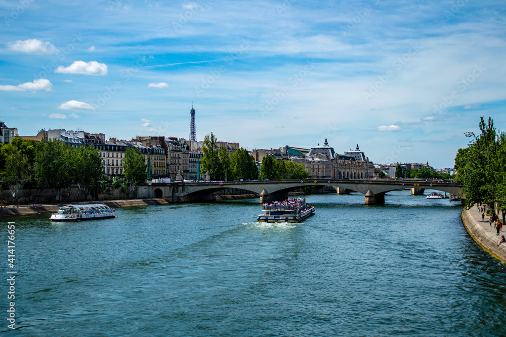 Paris, France - July 21, 2019: View of river Seine with passenger boats in Paris, France Paris, France - July 21, 2019: View of river Seine with passenger boats in Paris, France